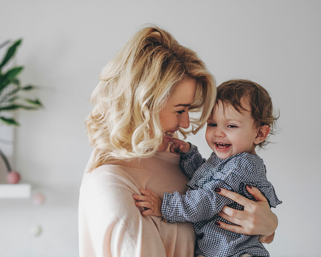 A mother smiling at her happy child, representing the family-friendly nature of Q Life products.